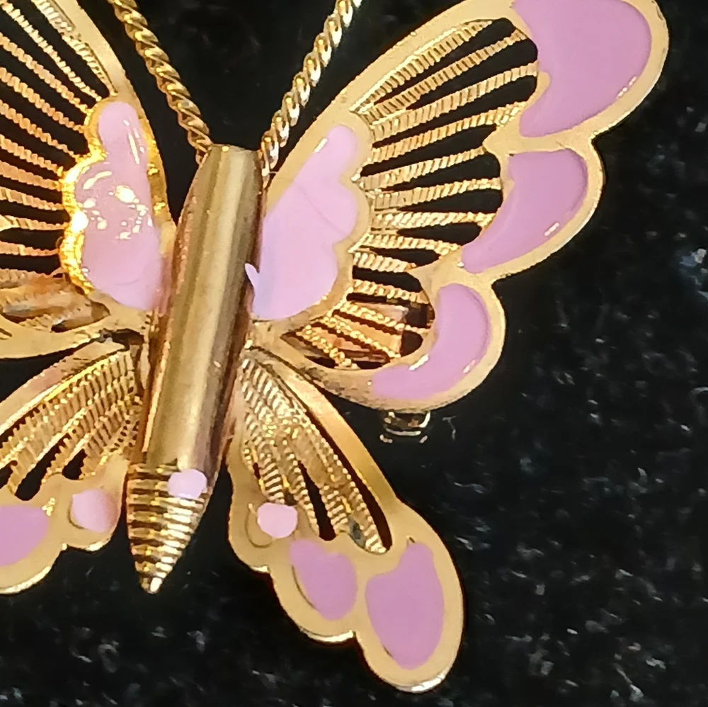Vintage goldtone filigree butterfly brooch with pink accents